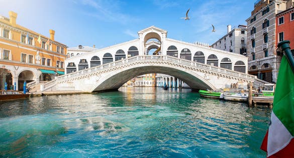 photo of beautiful view from the canal grande to the famous rialto bridge in Venice, Italy, without people and clear, emerald water.