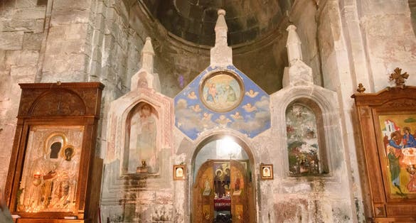 Photo of Interior of Church of Holy Trinity in Gergeti monastery. Face of Saint Mary from miraculous icon of Our Lady of Gergeti.