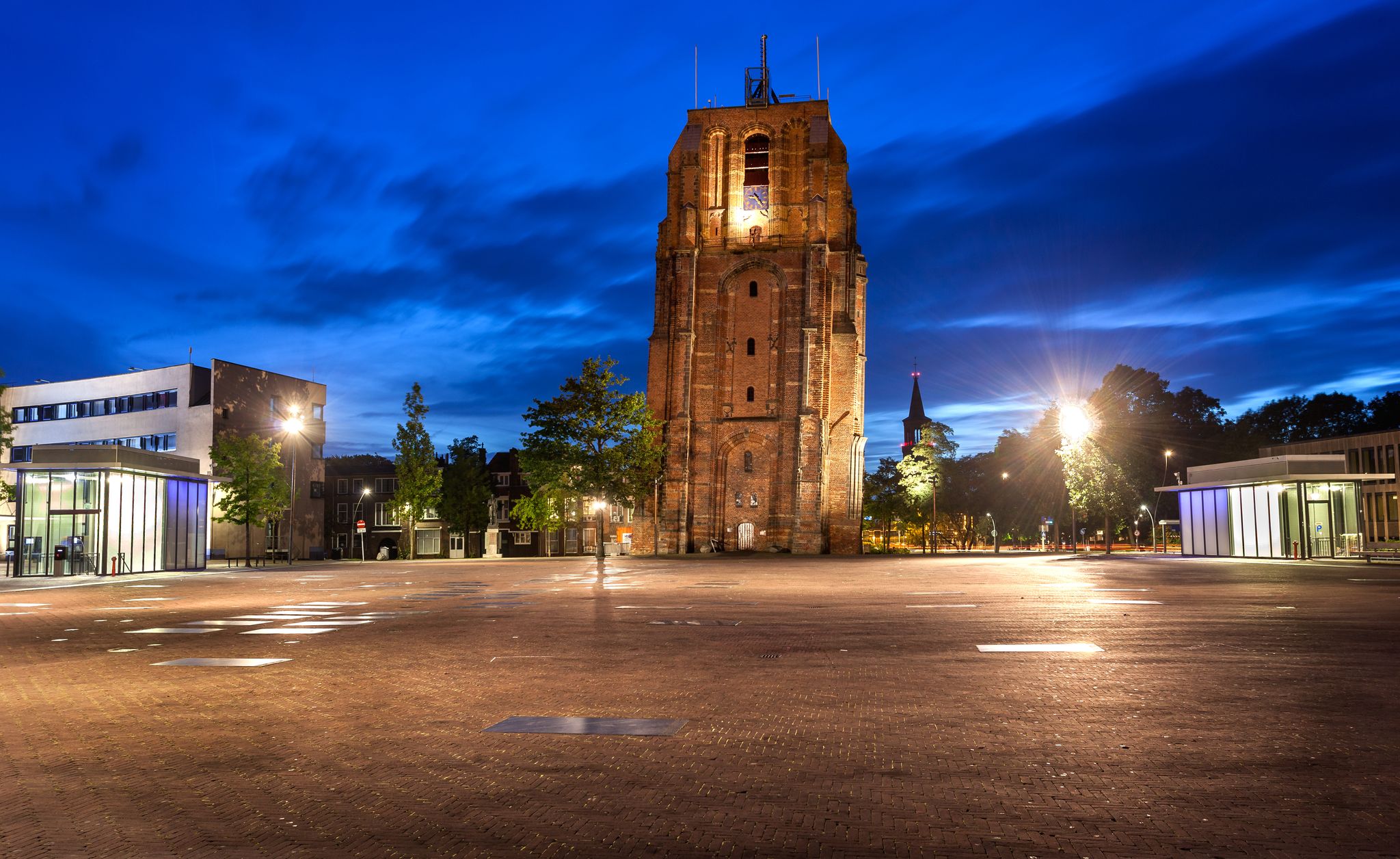 photo of Oldehove is an unfinished church tower at night in the medieval center of the Dutch city of Leeuwarden, Netherlands.