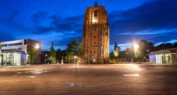 photo of Oldehove is an unfinished church tower at night in the medieval center of the Dutch city of Leeuwarden, Netherlands.