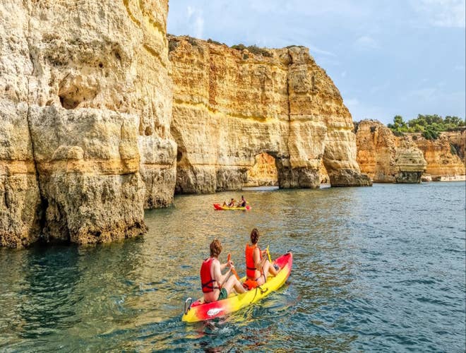 Kayaking near golden cliffs along the Algarve coast, a popular activity in Portugal in August..jpg