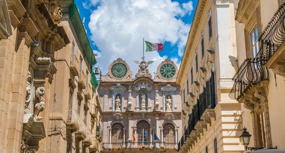 Scenic sight in Trapani old town with the Palazzo Senatorio in the background. Sicily, Italy.
