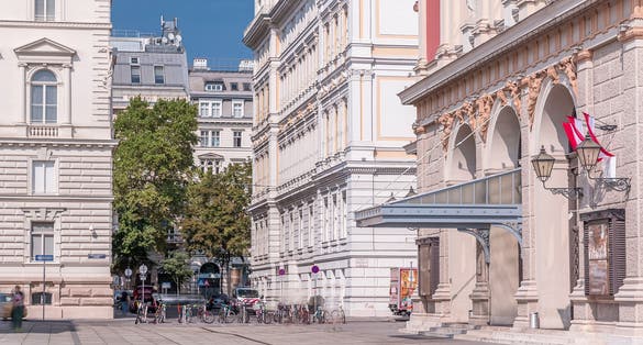 photo of view of The Wiener Musikverein timelapse (Viennese Music Association) is a famous Vienna concert hall. It was built in 1870. Street with green trees on a background,Vienna Austria.