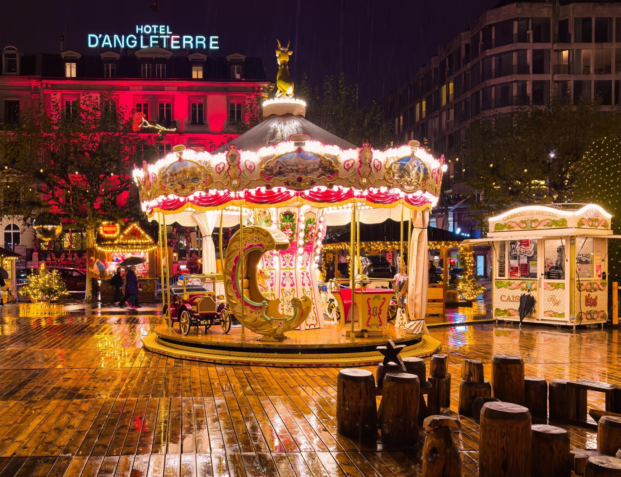 Vintage carousel lit up at night during the Geneva Christmas Market in Switzerland..jpg