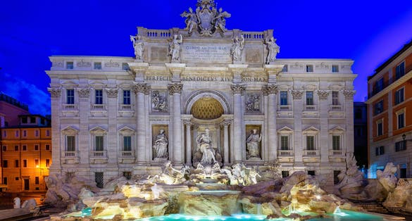 photo of night view of Rome trevi fountain (Fontana di trevi) in Rome, Italy. Trevi is most famous fountain of Rome. Architecture and landmark of Rome.