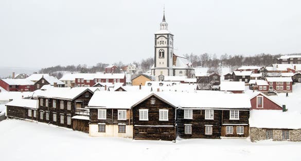 Overview of Roros (Røros), a Norwegian town on the UNESCOs world heritage list. The famous church and the small wooden houses are covered with snow a cold day in January.