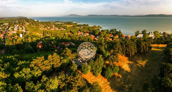photo of an aerial view of Orb lookout point in Balatonboglar Hungary. Lake balaton and Bafdacsony mountain is on the background. This place is next to an adventure park.