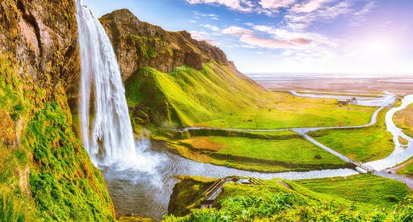 photo of beautiful Seljalandsfoss waterfall in Iceland during the sunset. Location: Seljalandsfoss waterfall, part of the river Seljalandsa, Iceland, Europe.
