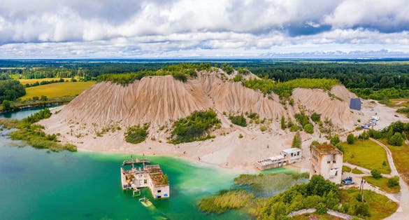 Photo of aerial view of the Rummu abandoned prison Tallinn Estonia lake beach.