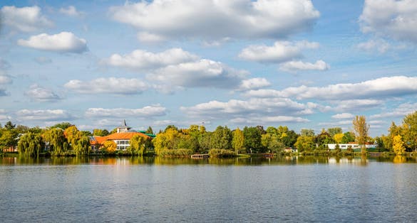 photo of view of Panoramic view of amazing landscape with a lake and blue sky with white clouds. Salt lake (Sosto) Nyiregyhaza, Hungary