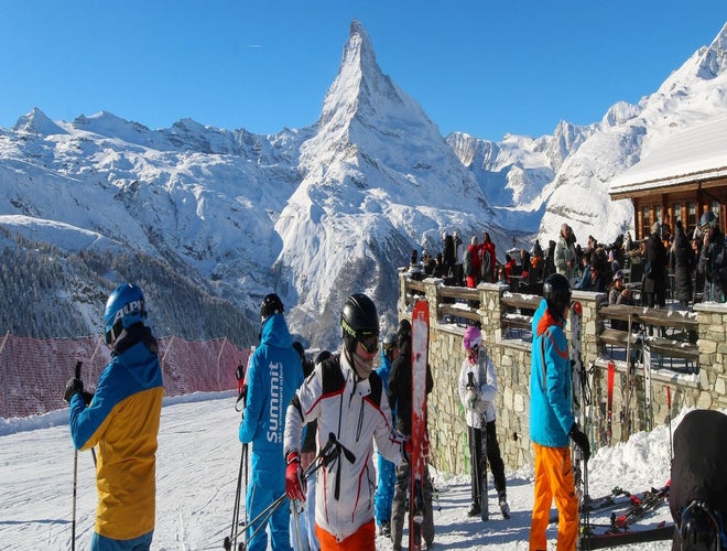 Skiers gearing up with the Matterhorn in the background on a clear winter day in Zermatt..jpg