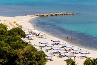 Photo of Kallithea sunny beach and summer resort at Kassandra of Halkidiki peninsula in Greece.