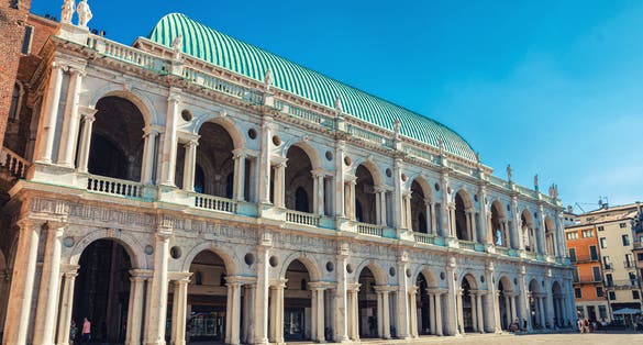 Photo of Basilica Palladiana renaissance building with balconies and columns in Piazza dei Signori square in old historical city centre of Vicenza city, Veneto region, Italy.