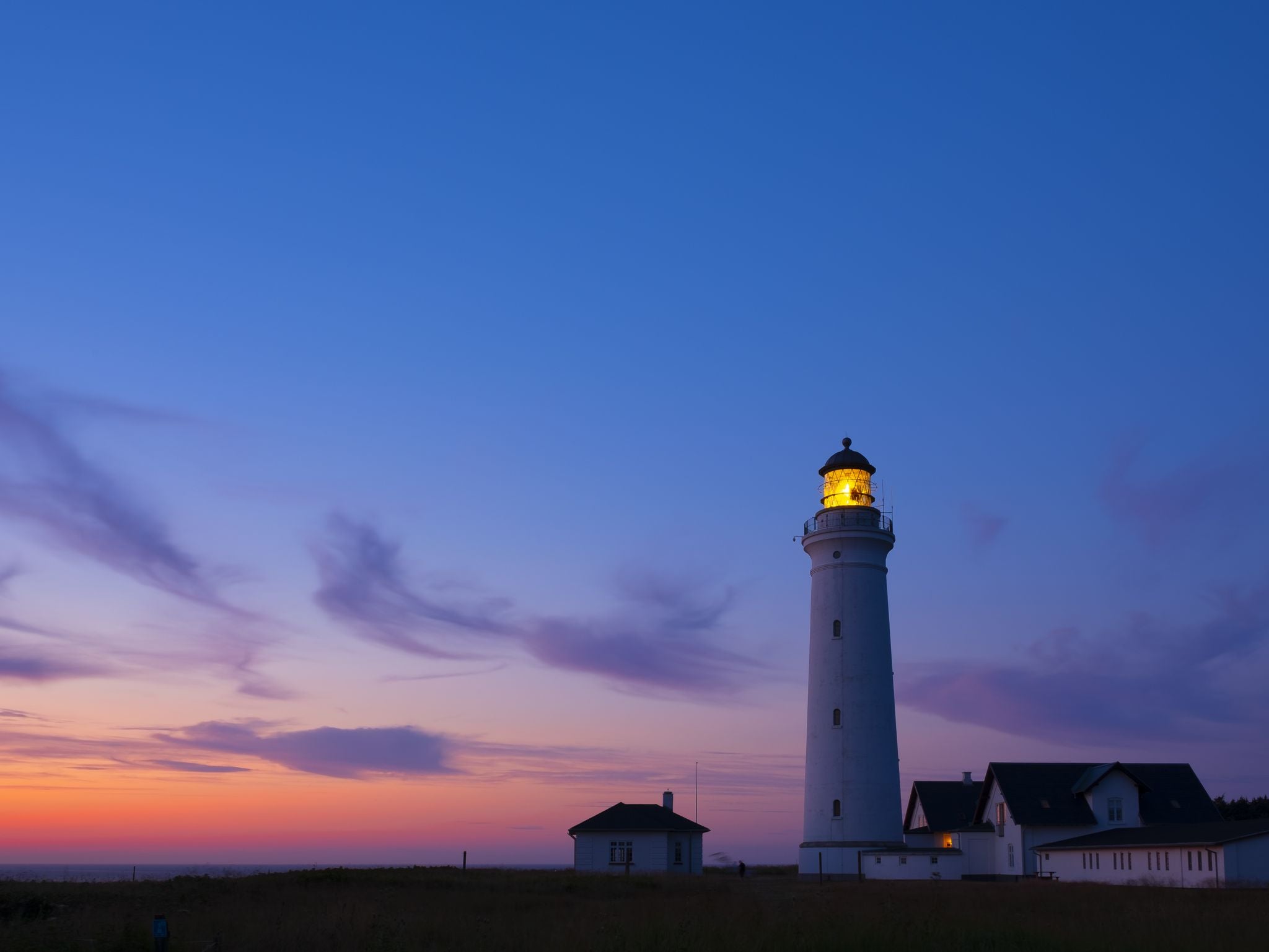 Photo of scenic view of lighthouse of Hirtshals at beautiful sunset in Denmark.
