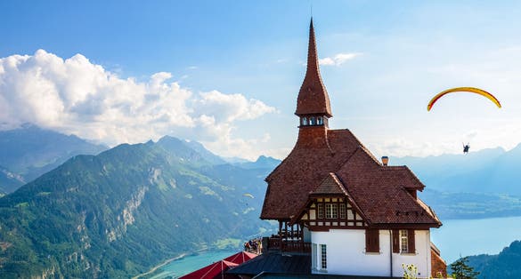 Photo of Stunning view of the top of Harder Kulm in Interlaken, Switzerland photographed in summer with paragliders flying around.