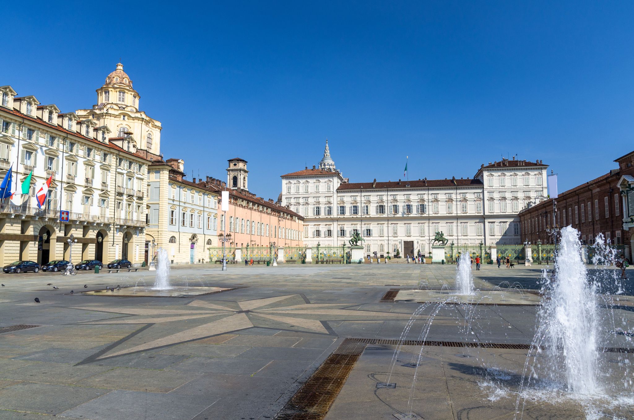 PHOTO OF Royal Palace Palazzo Reale and San Lorenzo church building on Castle Square Piazza Castello with fountains and monuments in historical centre of Turin Torino city with clear blue sky, Piedmont, Italy .