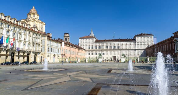 PHOTO OF Royal Palace Palazzo Reale and San Lorenzo church building on Castle Square Piazza Castello with fountains and monuments in historical centre of Turin Torino city with clear blue sky, Piedmont, Italy .