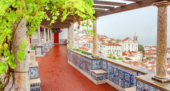 Photo of view of Lisbon famous view from Miradouro de Santa Luzia tourist viewpoint over Alfama old city district at night with cruise liner. Lisbon, Portugal.