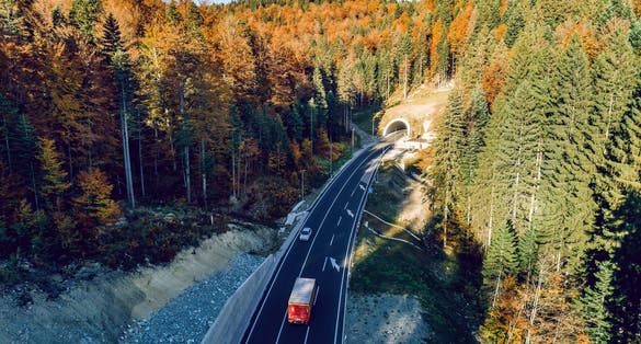 Aerial drone view of mountain overpass and modern road with tunnel Karaula in Bosnia and Herzegovina. Connection between Sarajevo and Tuzla. Toned image.