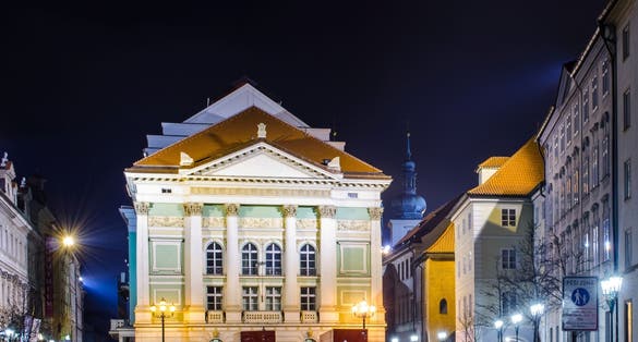 Photo of night view of the illuminated stavovske divadlo theatre where mozarts piece don giovanni had international premiere. Prague old town, Czechia.