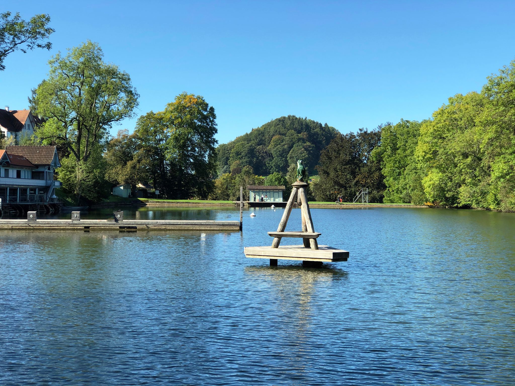 photo of people enjoying the view of the lake Mannenweier pond its three ponds recreation Drei Weieren in St. Gallen, Switzerland.