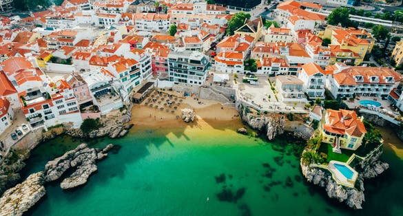 Photo of aerial view of Praia da Rainha and historic city centre of Cascais with it's beautiful beach, Portugal.
