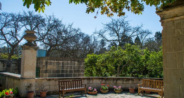 Bench in the shade in the San Anton gardens, Attard, Malta.