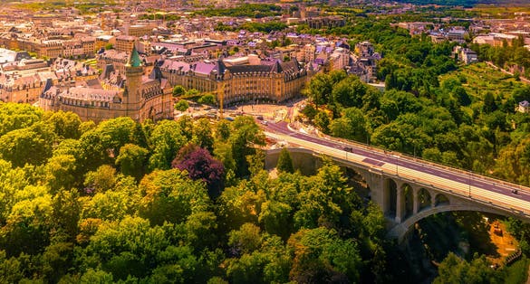 photo of panoramic aerial view of adolph bridge, Fort burbon and musee de la banque in luxembourg on a beautiful summer day, Luxembourg.