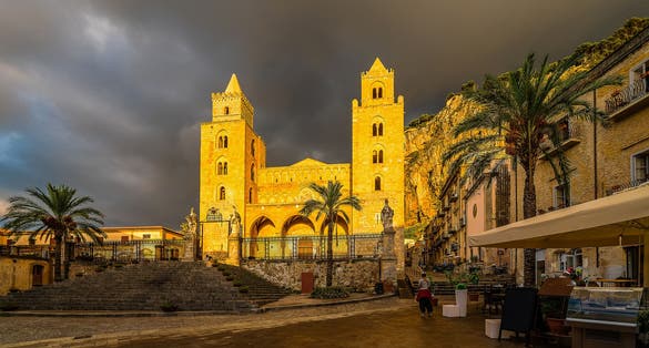 photo of The Cathedral of Cefalu in golden sunset light after rain, Sicily island, Italy .