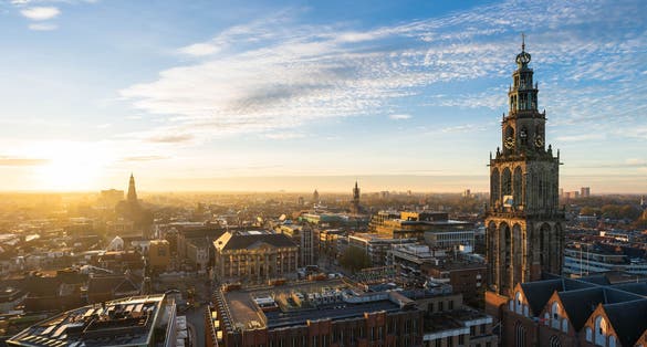 The sun setting at the Martinitoren and the historical city centre of Groningen on a beautiful afternoon.