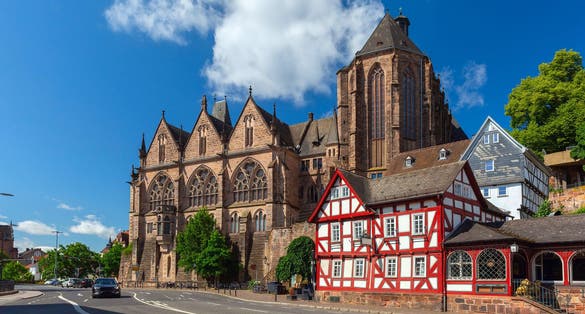 Photo of Medieval street with traditional half-timbered houses and University Church, Marburg an der Lahn, Hesse, Germany.