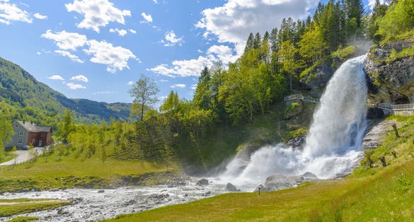 Photo of Steinsdalsfossen Waterfall, one of the most visited tourist sites in Norway, located in the village of Steine in the municipality of Kvam in Hordaland county.
