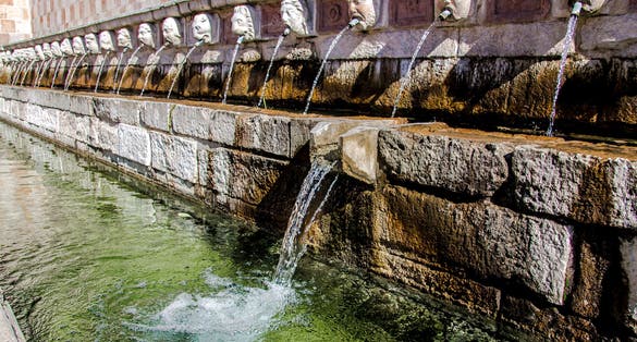 Fountain of the 99 Spouts (Fontana delle 99 cannelle), Historic fountain with 99 jets distribuited along three walls, L Aquila, Italy.