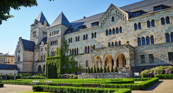 Photo of historic stone imperial castle with a garden in Poznan, Poland.