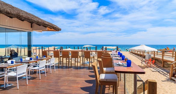 Photo of terrace of a restaurant on Armacao de Pera beach in Algarve region, Portugal.