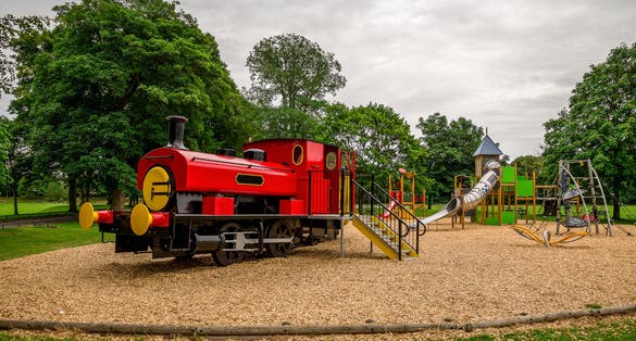 Photo of Large red train in Seaton park outdoor children playground, Aberdeen city, Scotland .