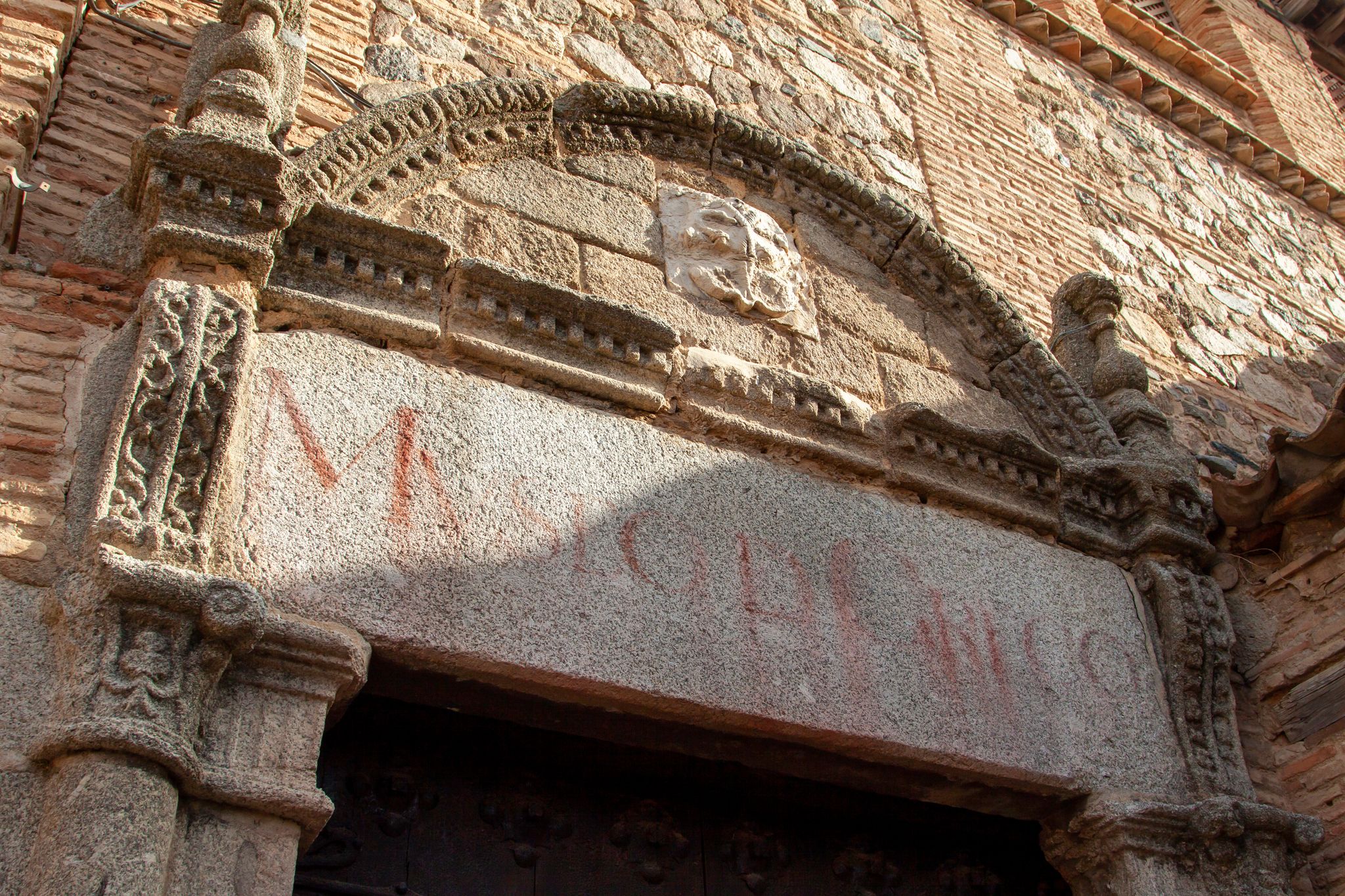 photo of Old entrance of El Greco Museum with its inscription in spanish on the stone at the jewish quarter of Toledo, Spain.