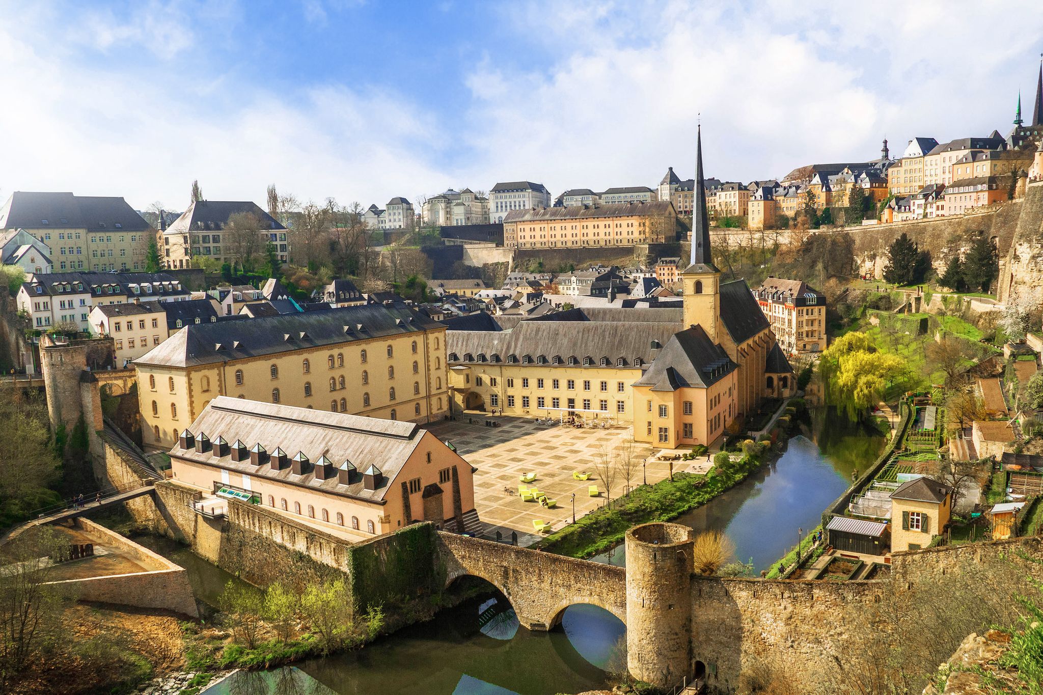 photo of panoramic view of Luxembourg city from observation deck above the bock casemates. Neumünster abbey, stone bridge above alzette river, colorful living houses, catholic churches.