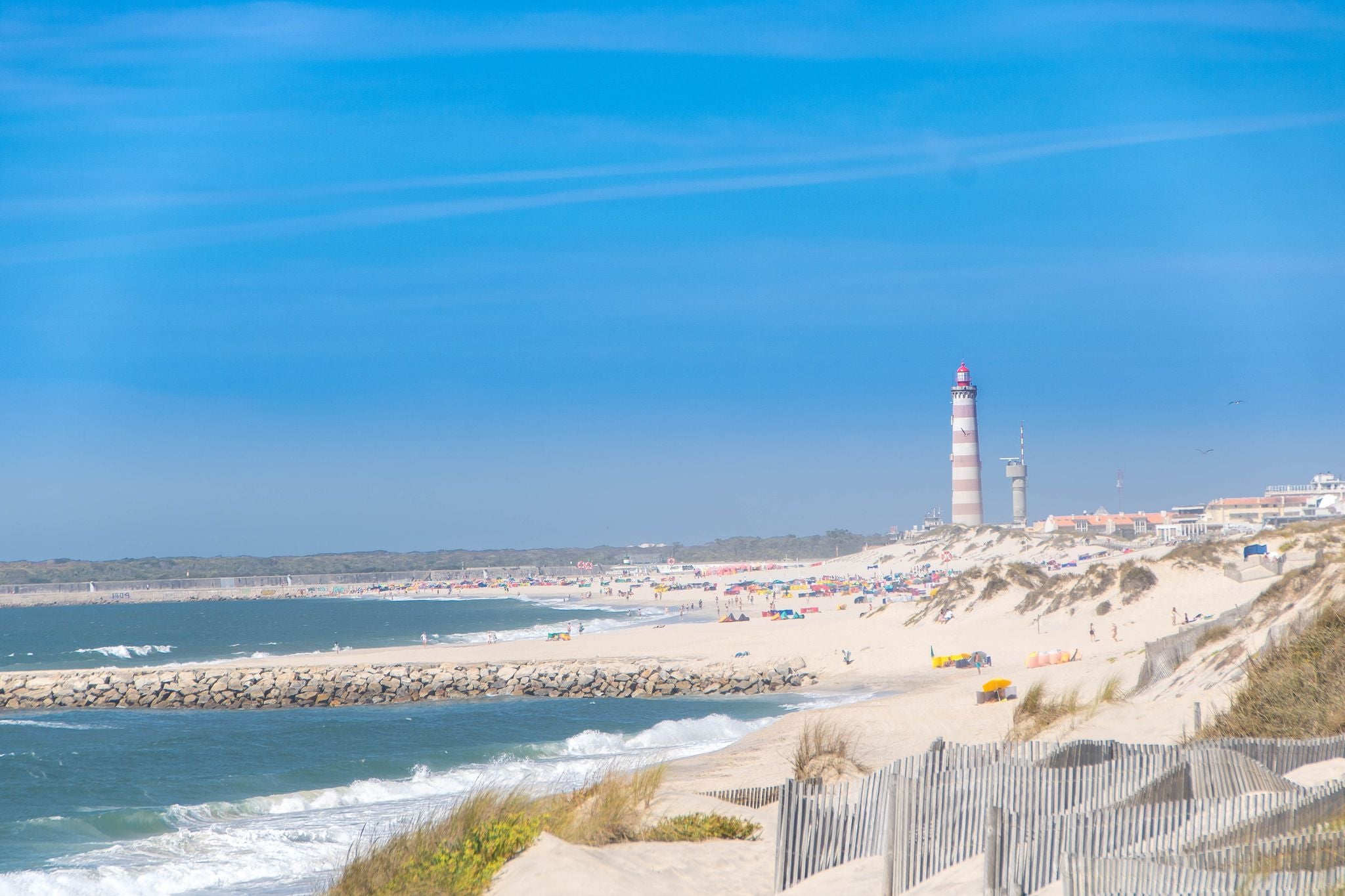 The beach of Costa Nova do Prado at Aveiro, and the Lighthouse of Praia da Barra on the Atlantico coast of Portugal