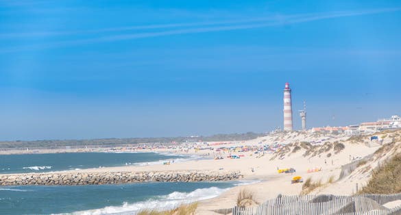 The beach of Costa Nova do Prado at Aveiro, and the Lighthouse of Praia da Barra on the Atlantico coast of Portugal