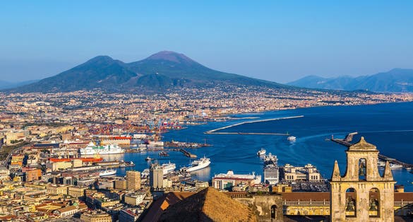 photo of Napoli (Naples) and mount Vesuvius in the background at sunset in a summer day, Italy, Campania,Ottaviano  Italy.