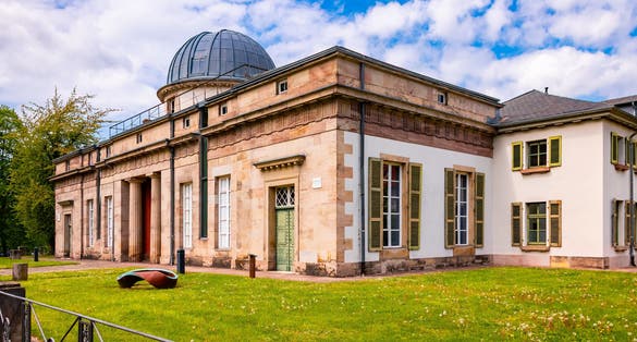 Photo of panoramic view of historic observatory with cupola dome for telescopes, a sight and monument in university town Goettingen, Germany.