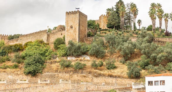 photo of morning view of the medieval Alcazaba of Badajoz or Templar castle in Badajoz, Spain.
