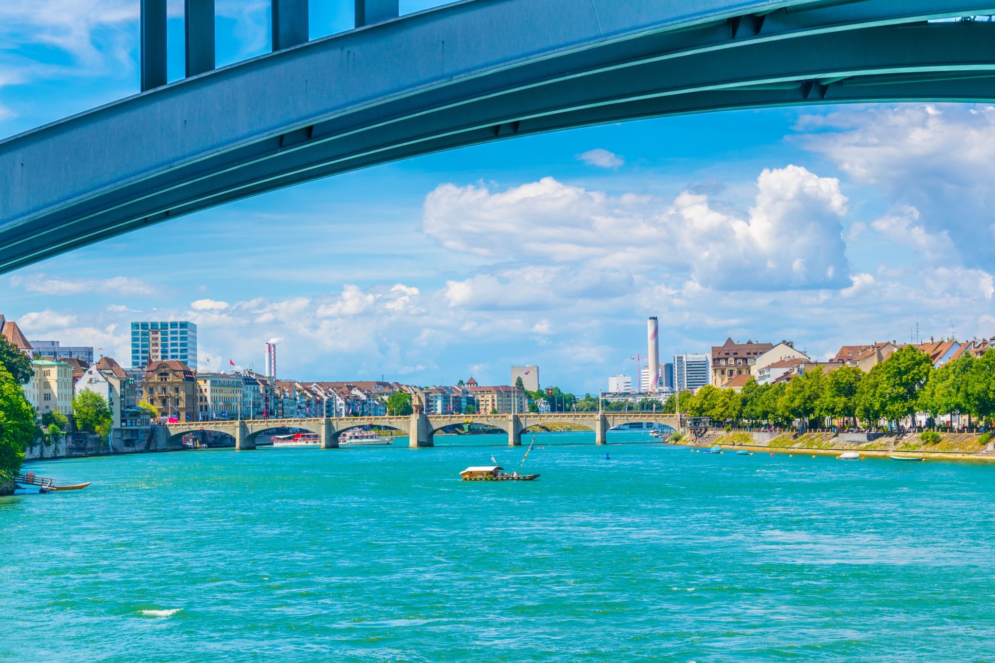 photo of riverside of Rhine in Basel viewed underneath the Wettstein bridge, Switzerland.