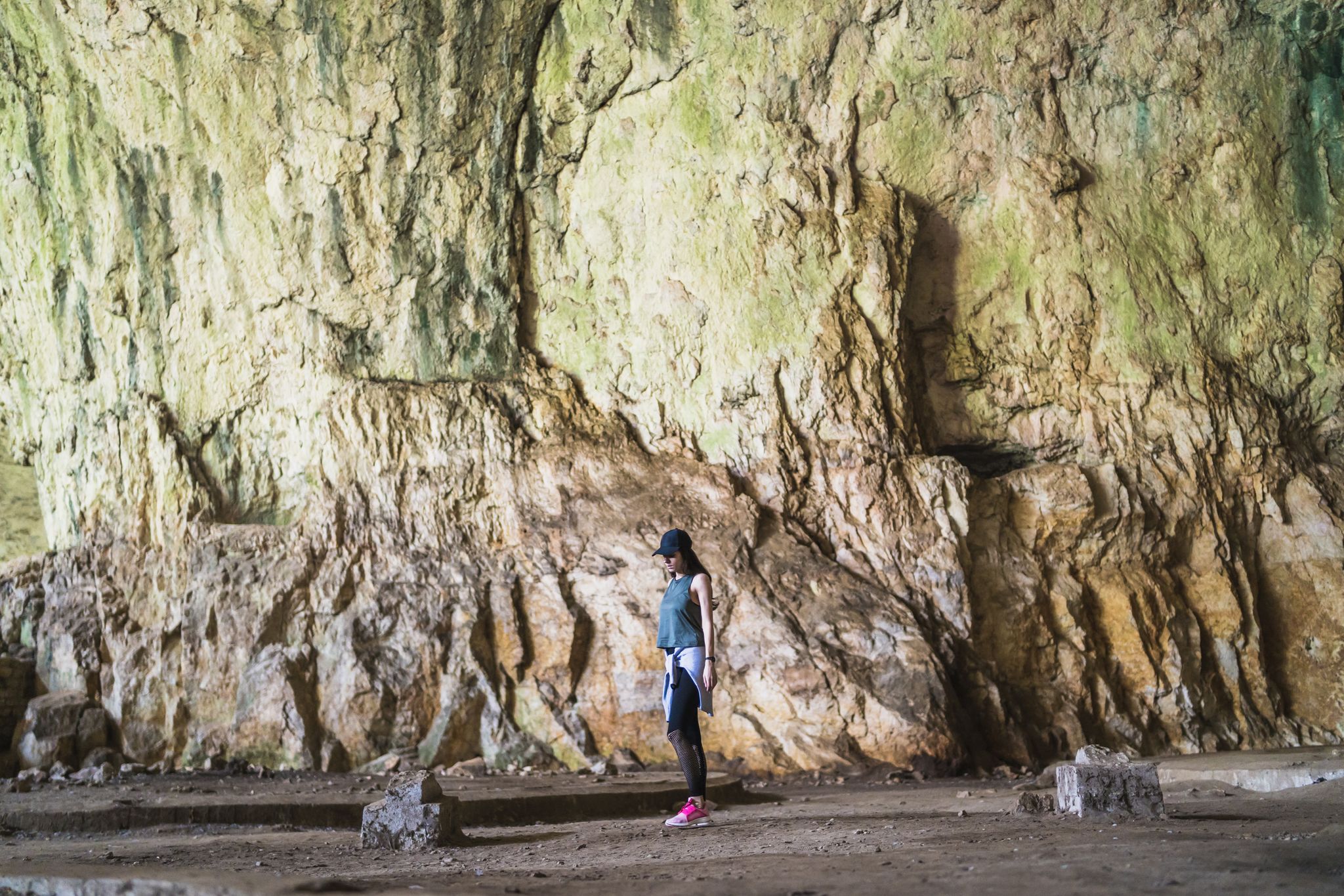 Photo of women exploring a devetashka cave near lovech, Bulgaria.