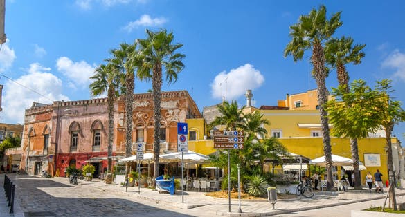 A sidewalk cafe with covered patio at the seaside promenade and boardwalk in the city of Brindisi, Italy, in the Puglia region.