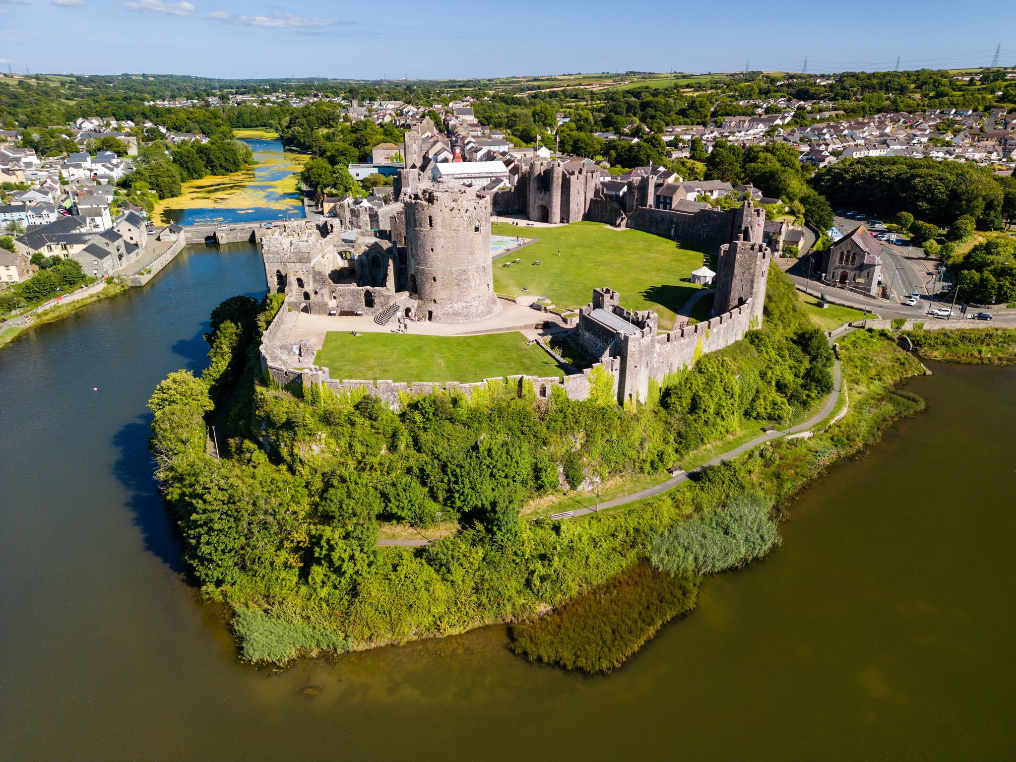 Photo of aerial view of the ruins of a large ancient Pembroke Castle castle in Wales.