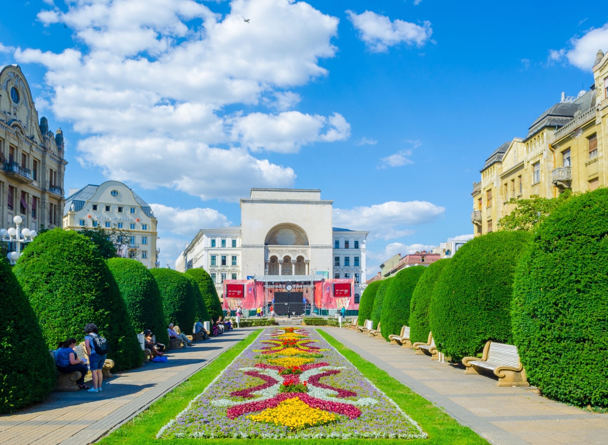 Photo of Victory square, piata victoriei Timisoara is a long square with green park surrounded by national opera on one side and the metropolitan cathedral on the other.