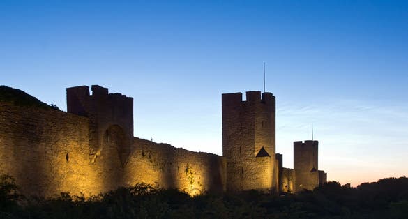 photo of city wall of Visby at night in Sweden.