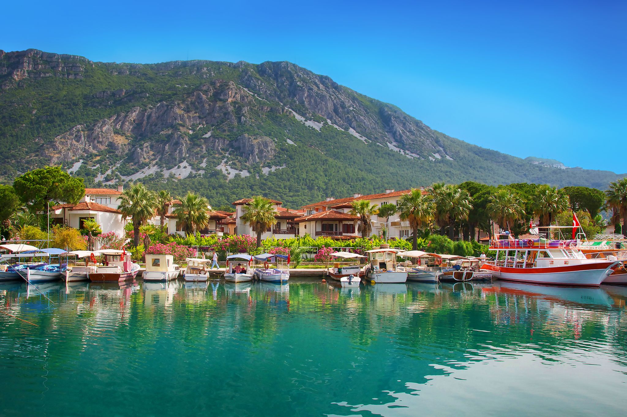 Photo of view on pier with boats and yachts, Marmaris pier, boats and yacht, Mediterranean sea, Turkey.